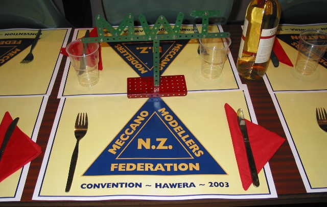 The Saturday evening dinner setting with special place mats, Manawatu Wanganui Taranaki (the host club) decoration and 'lubricant'.
